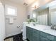 Bathroom featuring a double vanity, black tile flooring and modern fixtures at 1012 Rockway Dr, Charlotte, NC 28205