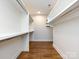 Walk-in closet featuring built-in shelving and hanging rods at 1012 Rockway Dr, Charlotte, NC 28205