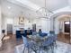 Open floor plan of dining room, kitchen with island and chairs, and view of the entrance at 1012 Rockway Dr, Charlotte, NC 28205