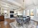 Open floor plan with coffered ceilings, fireplace, living area, dining area with glass table and view of the outdoors at 1012 Rockway Dr, Charlotte, NC 28205
