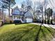 A view of the charming two-story home with a well-manicured lawn and a driveway at 1012 Rockway Dr, Charlotte, NC 28205