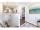 Hallway with hardwood floors, white walls, modern art, and a view of the staircase below at 1012 Rockway Dr, Charlotte, NC 28205