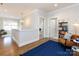 A hallway with a cozy chair, a bookshelf, modern lighting, and an open view of a nearby staircase at 1012 Rockway Dr, Charlotte, NC 28205