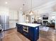 Open-concept kitchen featuring a large island with white countertops, stainless steel appliances, and modern pendant lighting at 1012 Rockway Dr, Charlotte, NC 28205