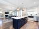 Bright kitchen with stainless steel appliances, dark countertops, an island, and an adjacent dining area with an elegant chandelier at 1012 Rockway Dr, Charlotte, NC 28205