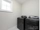 Laundry room featuring side-by-side front load washer and dryer at 1012 Rockway Dr, Charlotte, NC 28205