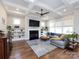 Living room with coffered ceiling, fireplace, large sectional sofa, and built-in bookshelves at 1012 Rockway Dr, Charlotte, NC 28205