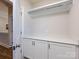 Mud room with white cabinets, countertops and hanging rack at 1012 Rockway Dr, Charlotte, NC 28205