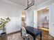 Bright office space with stylish light fixture, desk, and view of the bathroom at 1012 Rockway Dr, Charlotte, NC 28205