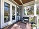 Cozy covered porch with french doors, seating, and outdoor decor, perfect for relaxing at 1012 Rockway Dr, Charlotte, NC 28205