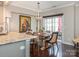 Bright dining area with a wooden table and chairs, granite counter, and access to a patio at 11611 Brachetto Pl, Charlotte, NC 28277