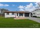 Ranch home with white exterior, landscaping, and attached garage at 17154 Frog Pond Rd, Oakboro, NC 28129