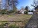 Spacious backyard, raised garden beds, and home view at 3315 Eastwood Dr, Charlotte, NC 28205