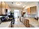 Functional kitchen with wood cabinets, stainless steel appliances, and a view to living area at 5044 Prosperity Ridge Rd, Charlotte, NC 28269