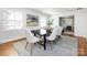 Elegant dining room featuring a modern table, stylish chairs, and an eye-catching art piece at 7037 Wrentree Dr, Charlotte, NC 28210