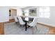 Elegant dining room featuring a modern table, stylish chairs, and an eye-catching art piece at 7037 Wrentree Dr, Charlotte, NC 28210