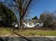 A charming one-story home with a well-maintained lawn, mature trees, and a welcoming exterior at 7037 Wrentree Dr, Charlotte, NC 28210
