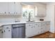 Bright kitchen with white cabinets, quartz countertops, stainless steel appliances, and a subway tile backsplash at 7037 Wrentree Dr, Charlotte, NC 28210