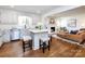 Open-concept kitchen with a center island flows into a cozy living area with a fireplace at 7037 Wrentree Dr, Charlotte, NC 28210