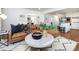 Open-concept living room with sightlines to kitchen and a modern leather sectional at 7037 Wrentree Dr, Charlotte, NC 28210