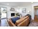 Inviting living room featuring a brick fireplace, hardwood floors, and modern decor at 7037 Wrentree Dr, Charlotte, NC 28210