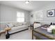 Cozy living room with neutral tones, a comfortable couch, and natural light from shuttered windows at 7037 Wrentree Dr, Charlotte, NC 28210