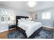 Comfortable primary bedroom featuring a large bed, side tables, and natural light at 7037 Wrentree Dr, Charlotte, NC 28210