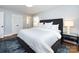 Comfortable primary bedroom with an accent rug, shuttered windows, and closet with bifold doors at 7037 Wrentree Dr, Charlotte, NC 28210
