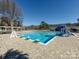 Community swimming pool featuring a slide, sun loungers, and a pergola covered seating area for residents enjoyment at 7037 Wrentree Dr, Charlotte, NC 28210