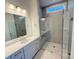 Bathroom with double vanity, quartz countertop, and a large shower at 7050 Wayfarer Dr # 0085, Charlotte, NC 28269