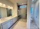 Bathroom with double vanity, quartz countertop, and a large shower at 7050 Wayfarer Dr # 0085, Charlotte, NC 28269