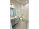 Bathroom with single vanity, white cabinets, and a bathtub at 7050 Wayfarer Dr # 0085, Charlotte, NC 28269