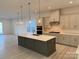 Modern kitchen with gray cabinets, white quartz island, and stainless steel appliances at 7050 Wayfarer Dr # 0085, Charlotte, NC 28269