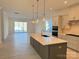 Modern kitchen with gray cabinets, white quartz island, and stainless steel appliances at 7050 Wayfarer Dr # 0085, Charlotte, NC 28269
