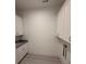 Laundry room with white cabinets and granite countertop at 7050 Wayfarer Dr # 0085, Charlotte, NC 28269