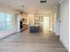 Open living room with light wood floors and access to the kitchen at 7050 Wayfarer Dr # 0085, Charlotte, NC 28269