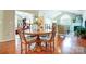 Bright dining room features hardwood floors and a charming wooden table with four chairs at 794 Ledgestone Ct, Tega Cay, SC 29708