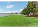 Large backyard with lush green grass, mature tree providing shade, and white fence, ideal for relaxation or recreation at 1003 Blue Range Rd, Indian Trail, NC 28079