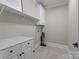 Bright laundry room with white cabinets and overhead storage at 1740 Withers Dr, Denver, NC 28037