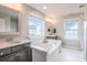 Bright bathroom featuring a large tub, double vanities, and ample natural light from two windows at 17611 Austins Creek Dr, Charlotte, NC 28278