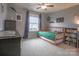 Bright, carpeted bedroom with playful decor, a window, and an orange metal bed frame at 17611 Austins Creek Dr, Charlotte, NC 28278