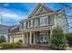 Charming two-story home with a welcoming front porch and meticulously manicured landscaping, enhancing its curb appeal at 17611 Austins Creek Dr, Charlotte, NC 28278