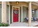 Inviting front porch with comfortable seating and a vibrant red front door, adorned with a floral wreath at 17611 Austins Creek Dr, Charlotte, NC 28278
