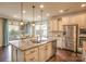 Spacious kitchen featuring a large island with sink, stainless steel appliances, and ample cabinet space at 17611 Austins Creek Dr, Charlotte, NC 28278