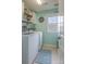 Well-lit laundry room with modern washer and dryer and decor at 17611 Austins Creek Dr, Charlotte, NC 28278