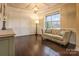 Bright living room with decorative wall paneling and a large window with couch at 17611 Austins Creek Dr, Charlotte, NC 28278