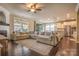 Open concept living room with hardwood floors, a large sectional sofa, and a view of the kitchen at 17611 Austins Creek Dr, Charlotte, NC 28278