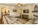 Comfortable living room featuring a sectional sofa, hardwood floors, and a ceiling fan at 17611 Austins Creek Dr, Charlotte, NC 28278