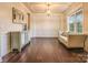 Bright living room with decorative wall paneling and a large window, with couch at 17611 Austins Creek Dr, Charlotte, NC 28278