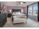 Spacious, carpeted main bedroom with a large window, a ceiling fan, and dark wood furniture at 17611 Austins Creek Dr, Charlotte, NC 28278